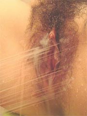 Asian amateur babe takes a shower and spreads wide her pussy