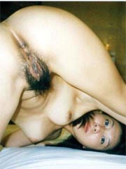 Smiling Asian teen showing her tight pussy